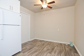 an empty room with a refrigerator and a ceiling fan  at Woodhaven, Everett, 98203